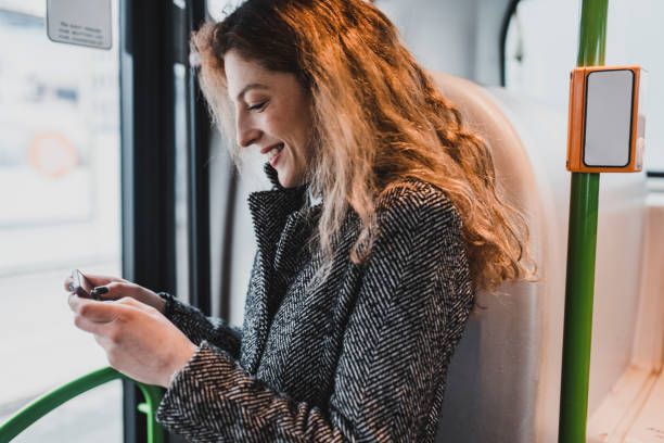 istock Woman using smartphone and riding with a bus 956773592