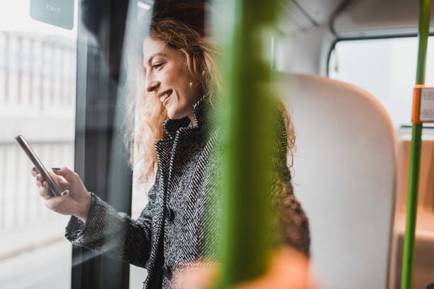 istock Businesswoman using smartphone on the bus 956773602