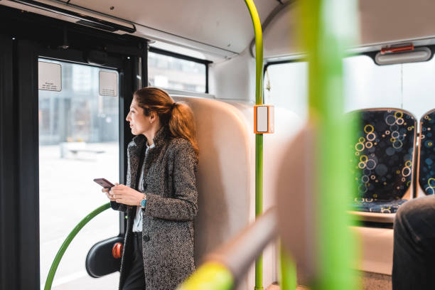 istock Businesswoman using smartphone on the bus 956773608