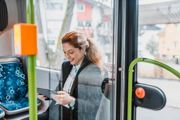 istock Businesswoman driving on the bus and using a digital tablet 956773622
