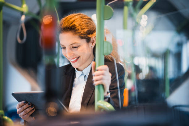 istock Woman with a digital tablet driving on the bus 956773662
