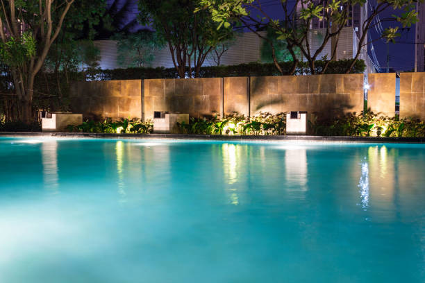 istock Lush pool lighting in backyard for luxury swimming pool design created by great lighting professionals. 956777242