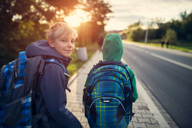 School boys walking to school Two school boys walking on sidewalk on way to school. Sunny day morning.
Shot with Nikon D850 way to school stock pictures, royalty-free photos & images