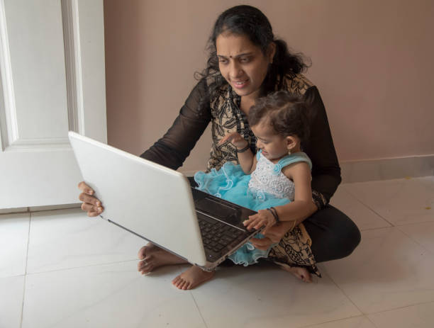 istock mother and daughter watching laptop 956778882
