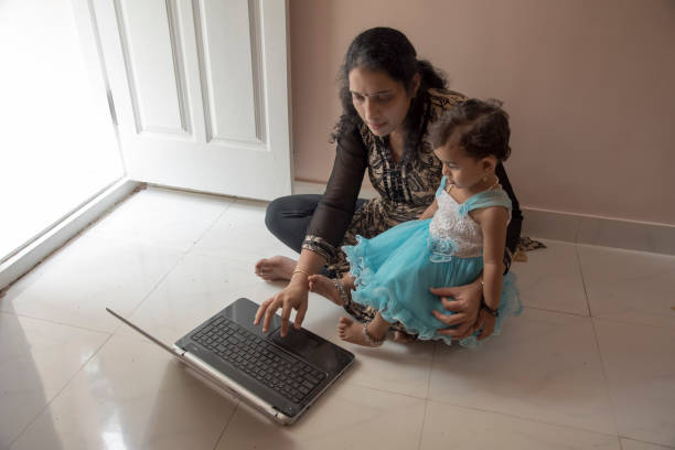 istock mother and daughter watching laptop 956778888