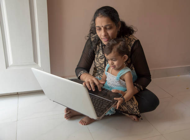 istock mother and daughter watching laptop 956778892