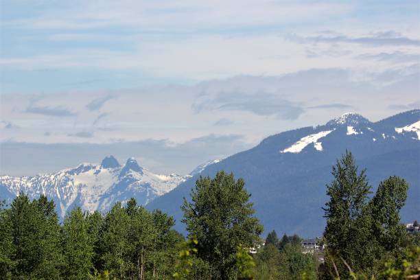 istock Vancouver skyline - snow capped mountain range from Burnaby Lake Park, on a Spring morning, Vancouver, Canada 956786476
