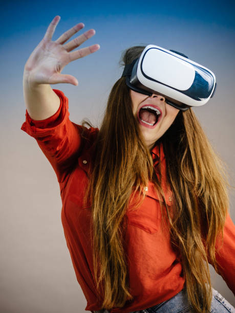 istock Girl wearing virtual reality goggles. 956786612