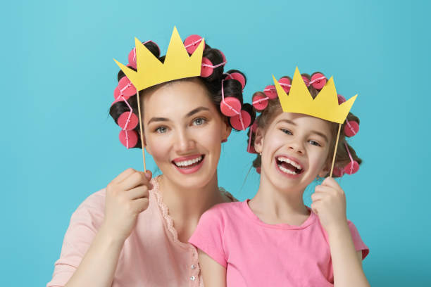 istock Mother and her daughter with a paper accessories 956787628