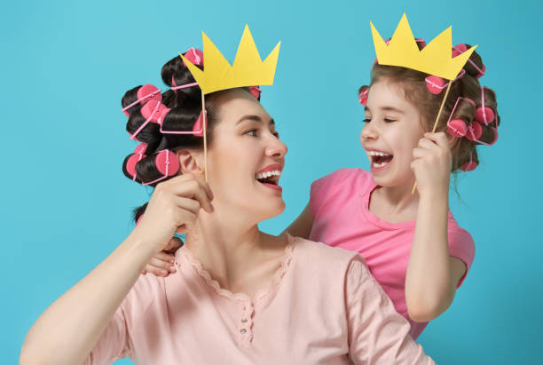 istock Mother and her daughter with a paper accessories 956787690