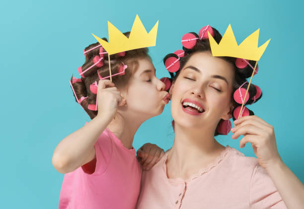 istock Mother and her daughter with a paper accessories 956787726