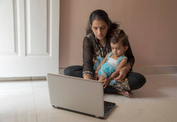 istock mother and daughter watching laptop 956791220