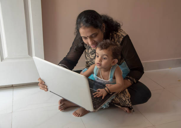 istock mother and daughter watching laptop 956791222