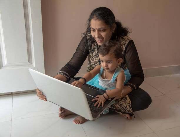 istock mother and daughter watching laptop 956791250