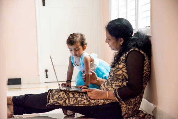 istock mother and daughter watching laptop 956791372
