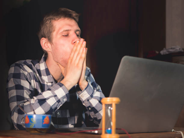 istock disappointed stressed young man sitting in front of laptop 956800386
