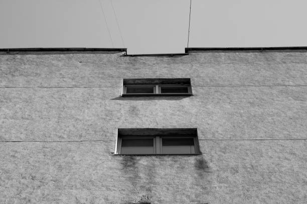 istock Windows and cement wall of old house in black and white 956804764