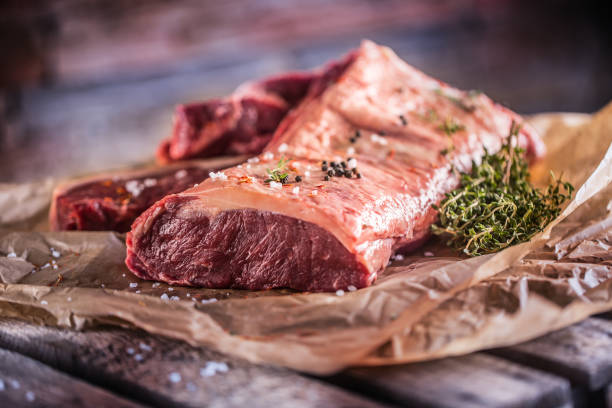 istock Raw rib eye beef steak with salt spices and herbs 956807506