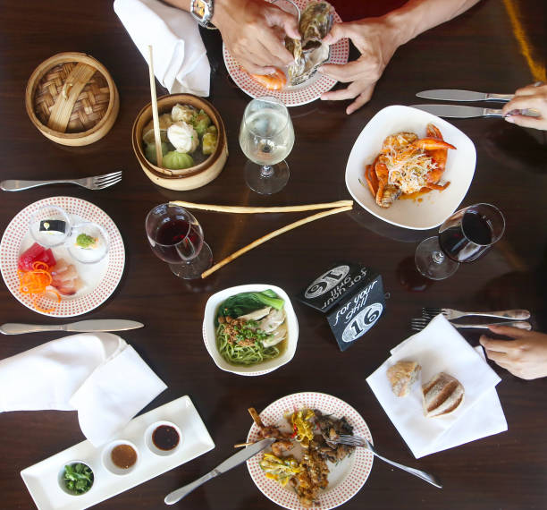 istock Friends having a dinner party. Different dishes on the restaurant table, top view 956810344