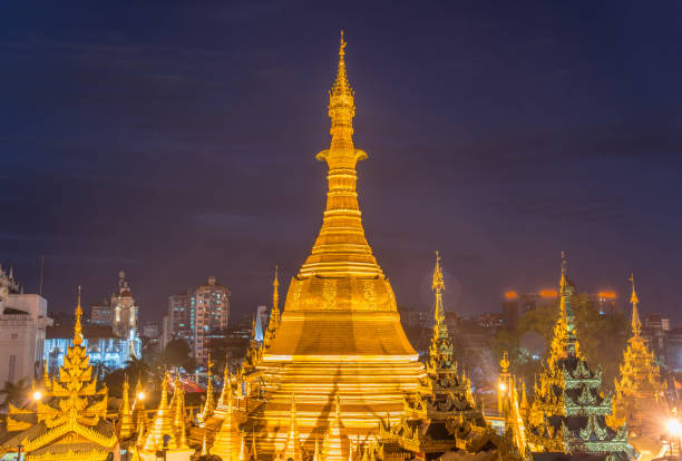 Scenery view of Sule pagoda one of an iconic Buddhist landmark in the centre of Yangon township of Myanmar. Shot of Sule pagoda at night. sule pagoda stock pictures, royalty-free photos & images