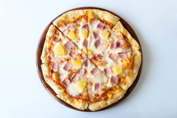 istock Hawaiian pizza on wooden plate on white background,clipping path. 956819104