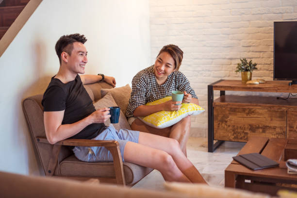 istock Young happy Asian couple at home 956819314