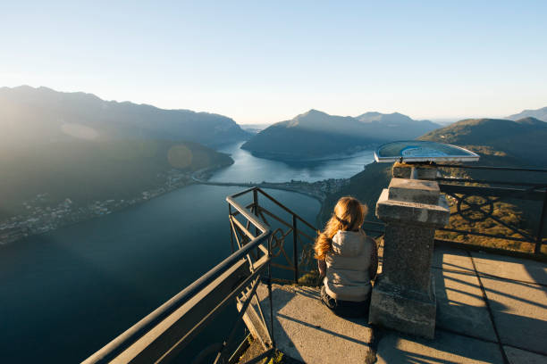 istock Woman looks out at Lake Lugano from elevated view point 956820128