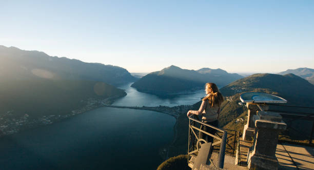 istock Woman looks out at Lake Lugano from elevated view point 956820134