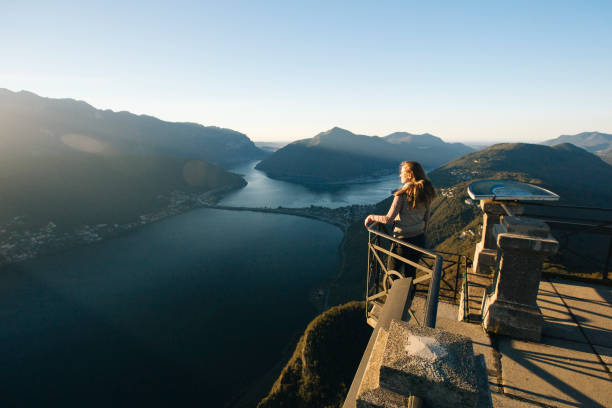 istock Woman looks out at Lake Lugano from elevated view point 956820142