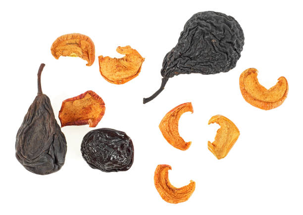 istock Dried fruits on a white background - pears, apples and prunes. Top view. 956820840