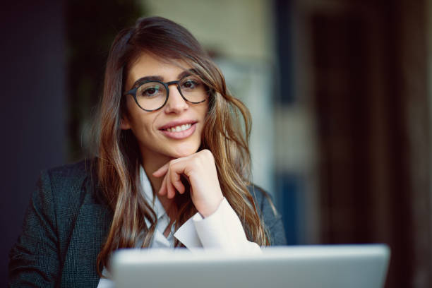 istock Young modern woman sitting in cafe and using laptop. 956824670