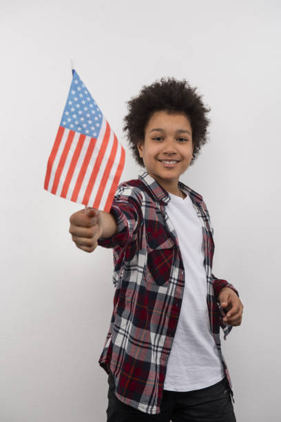 istock Positive cheerful boy holding a US flag 956826794
