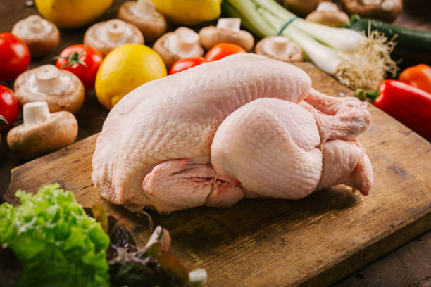 Fresh poultry chicken on wooden table ready to cook