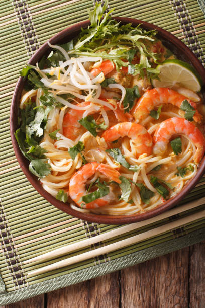 istock Malaysian laksa soup with prawns close up in a bowl. vertical top view 956830852