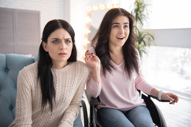 istock Sincere two sisters viewing movie 956835690