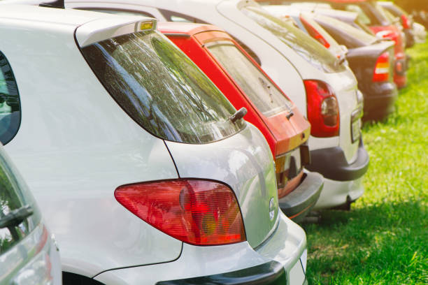 istock Cars parked on green grass 956839978