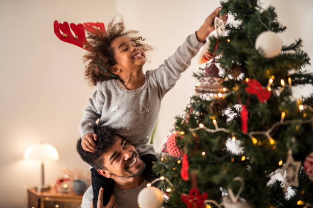 istock Putting ornaments on the Christmas tree 956840050