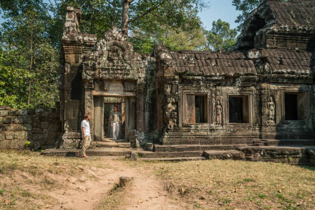 istock Young couple contemplating ancient temple in Cambodia 956841016
