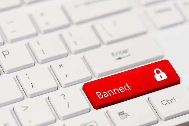 istock red key with text Banned and closed padlock icon on white laptop keyboard 956841124