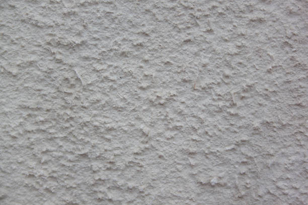 istock Gray plastered handmade rough wallpaper. Beautiful decorative gray plastered wall. 956841222