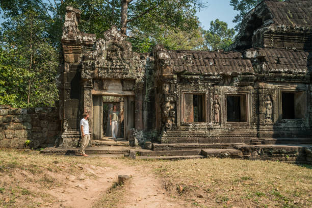 istock Young couple contemplating ancient temple in Cambodia 956842128