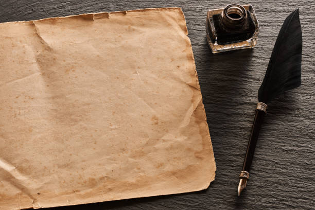 istock Feather pen and and blank paper sheet 956845844