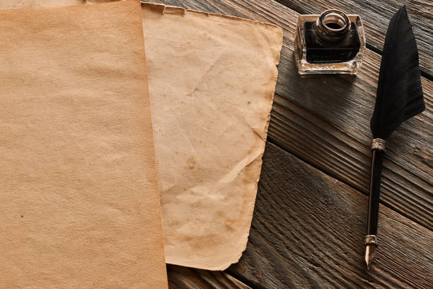 istock Feather pen and blank paper sheet 956845880