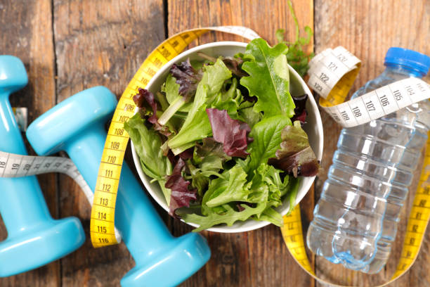 istock salad with dumbbell and water 956846504