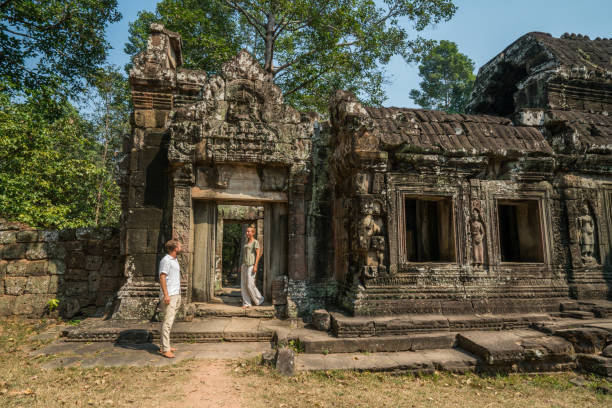 istock Young couple contemplating ancient temple in Cambodia 956850694