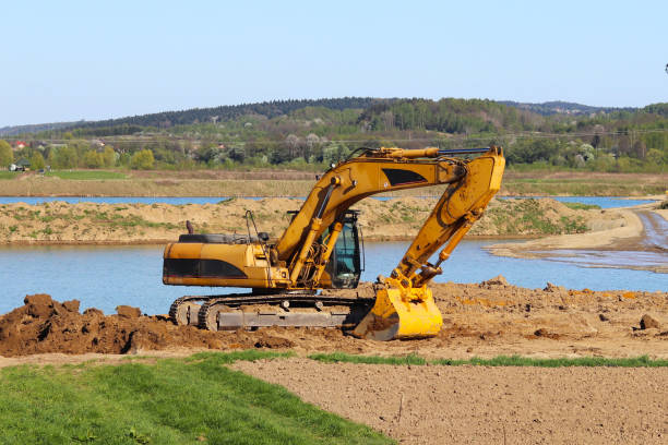 istock The excavator loads the dump truck with soil. 956853918