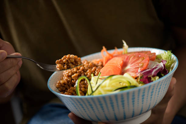 istock young man eating a buddha bowl 956853972
