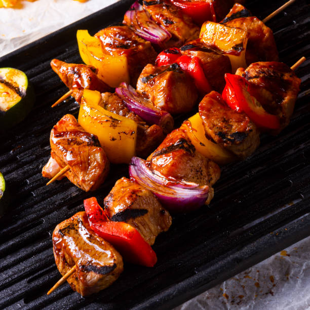 istock Rustic shish kebab skewers with marinated ham meat paprika and red onion 956855738