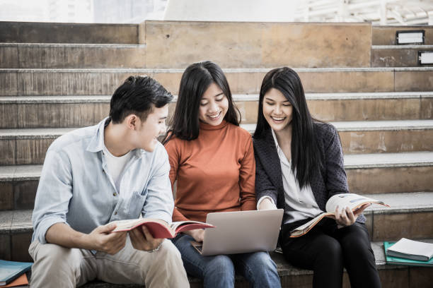 istock Group students studying researching on laptop Together sitting at college. 956859928