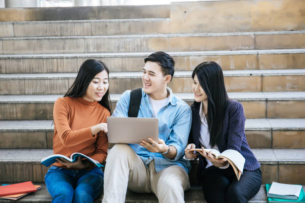 istock Group students studying researching on laptop Together sitting at college. 956860020